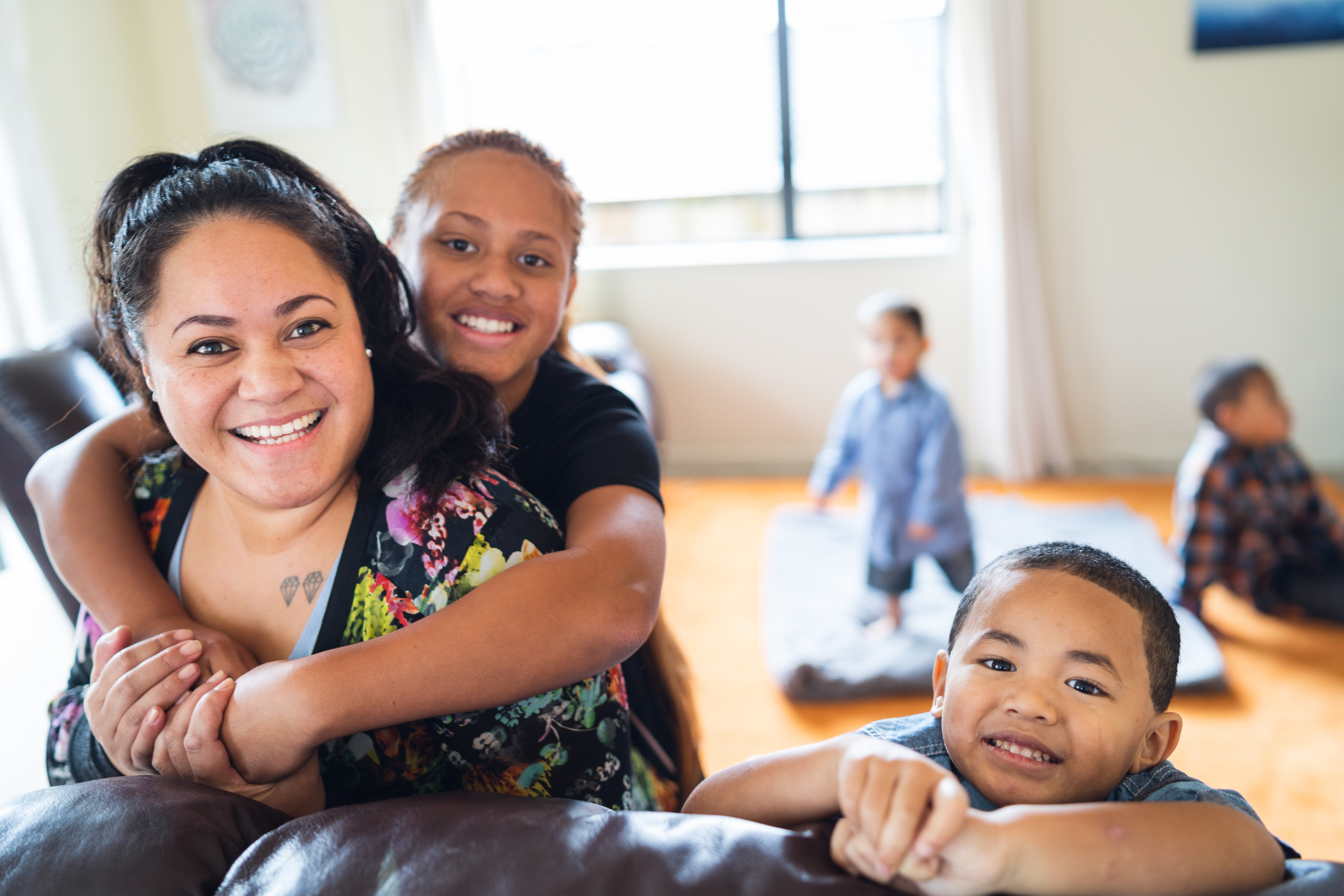 Maori mother with kids at home.